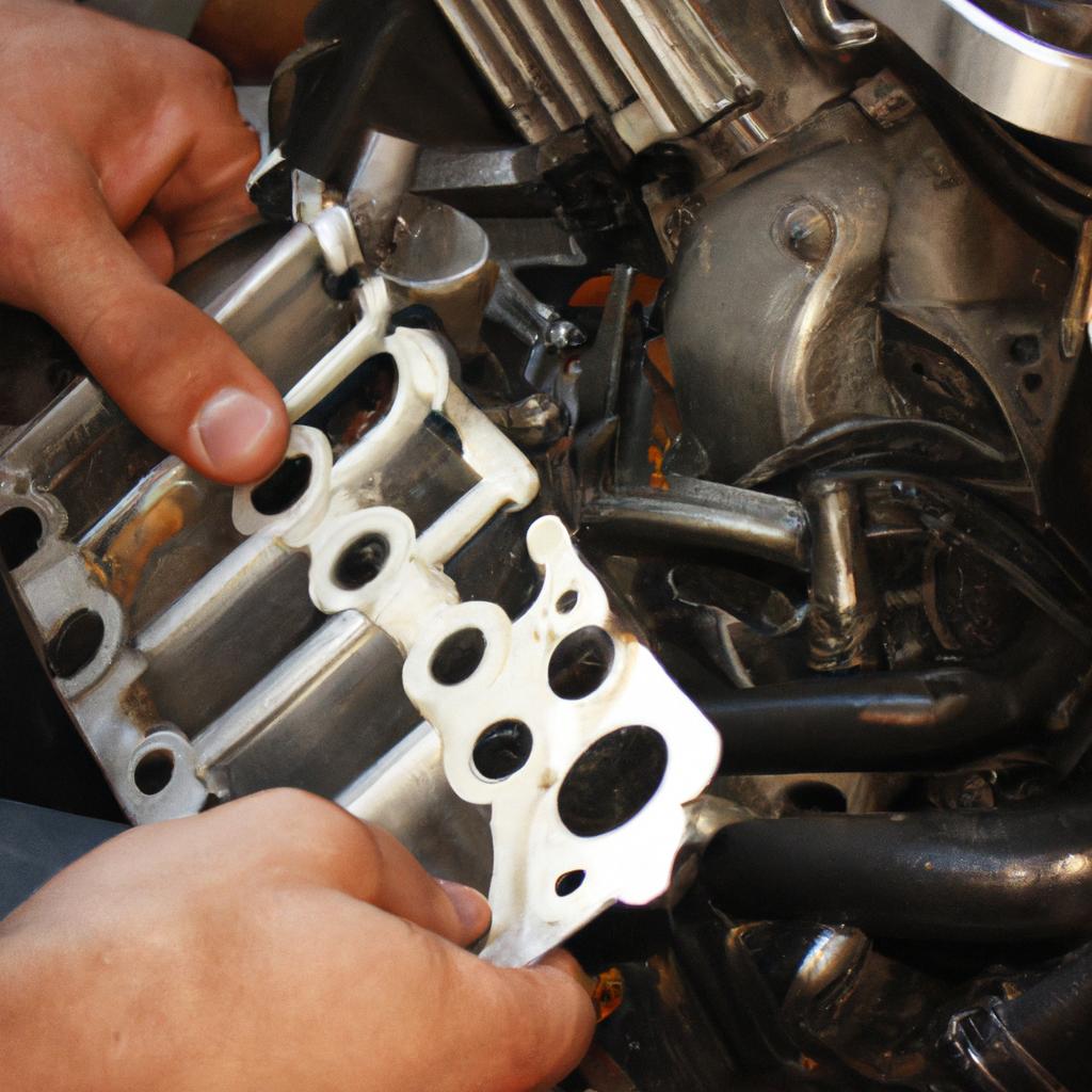 Person examining motorcycle engine parts