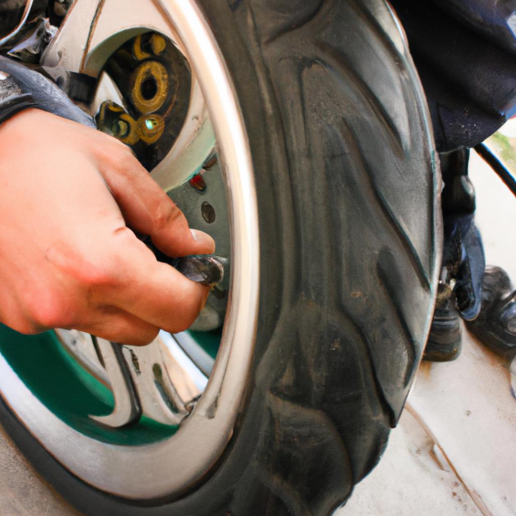 Person checking motorcycle tire pressure